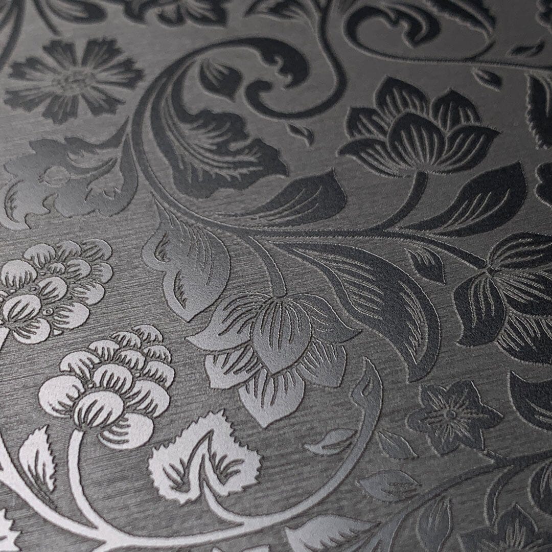 Zoomed in detailed shot of the highly detailed midnight floral engraving on matte black impact acrylic iPhone 16 Pro MagSafe Case by Keyway Designs