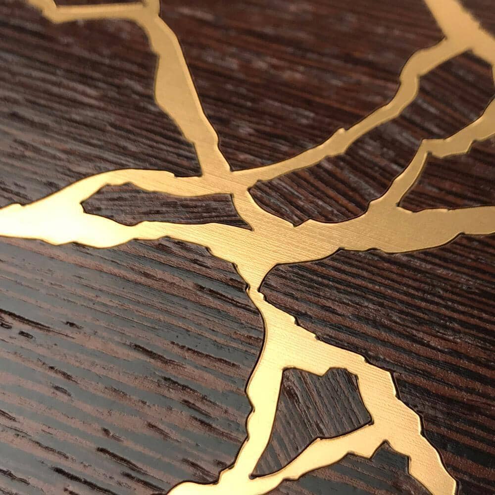 Zoomed in detailed shot of the Kintsugi inspired Gold and Wenge Wood iPhone 16 Pro Max MagSafe Case by Keyway Designs