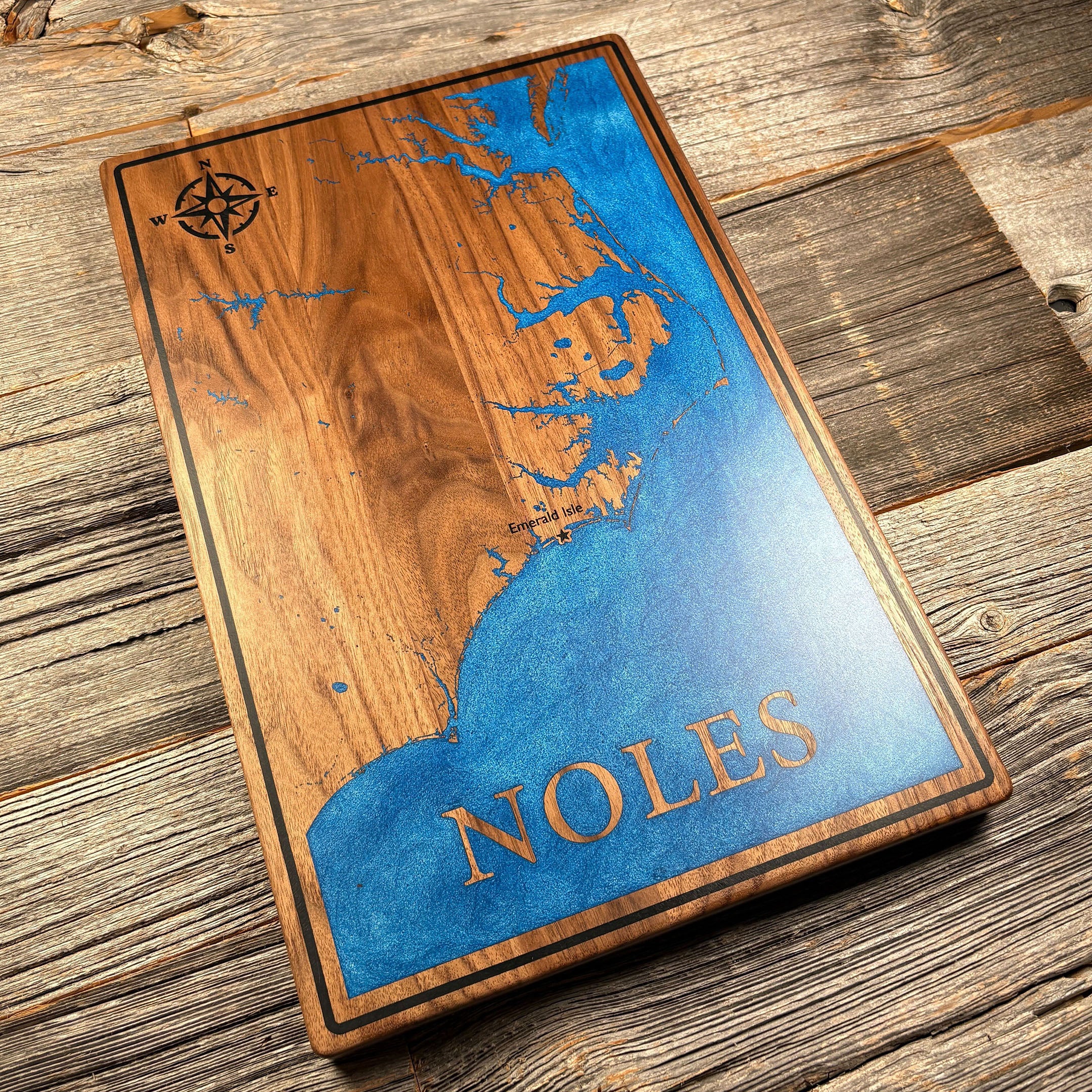 Personalized wooden wall art featuring a blue epoxy resin inlay map of Emerald Isle with a compass rose and the name 'Noles,' perfect for custom home décor or gifts.